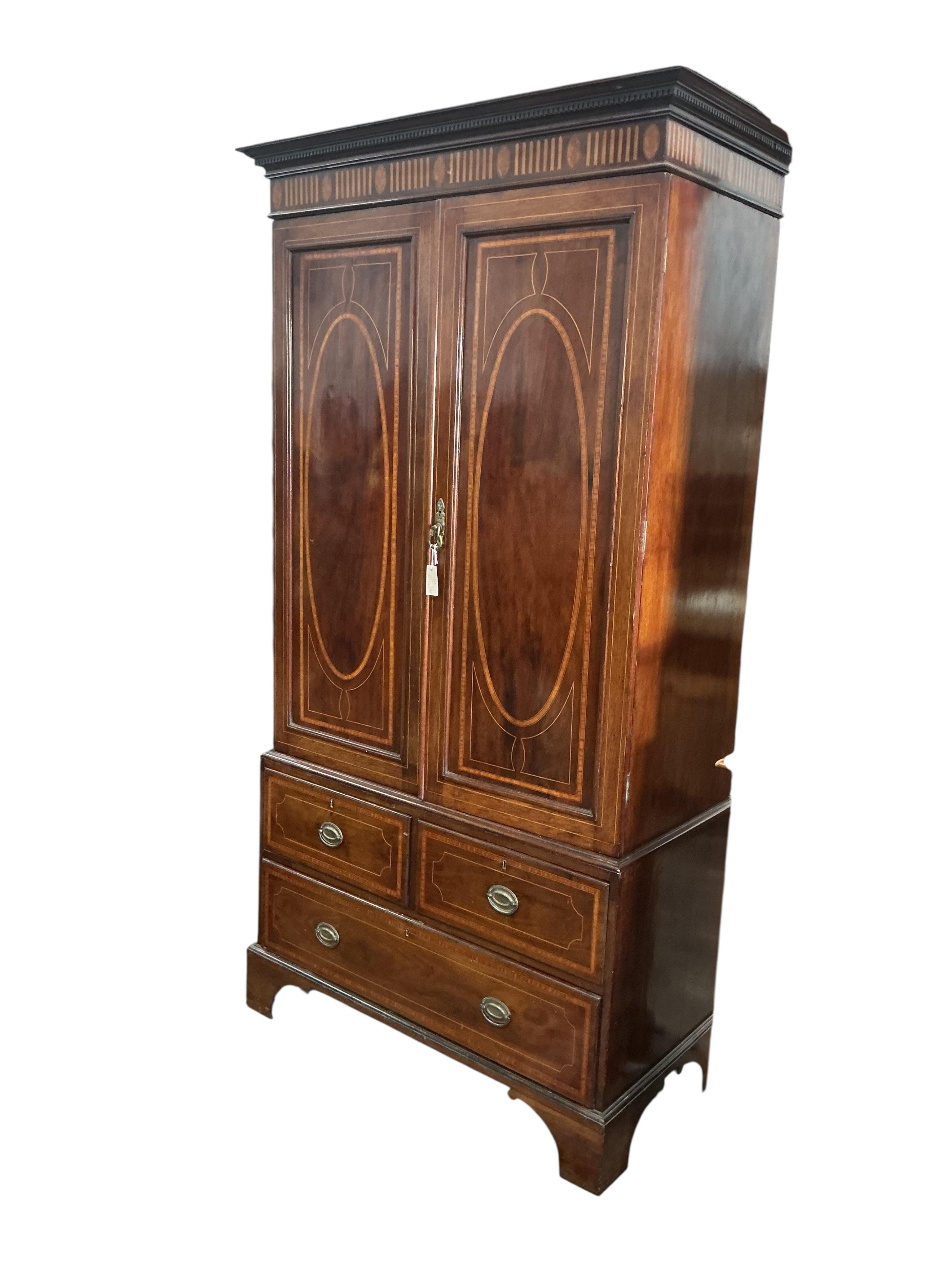 An Edwardian satinwood banded mahogany linen press, width 122cm, depth 58cm, height 230cm